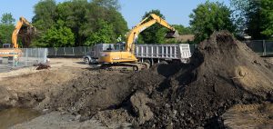 Construction excavator removing contaminated soil
