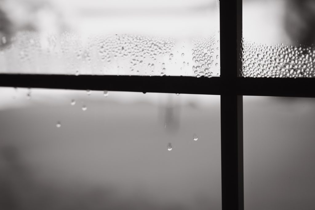 cross shape of window panes with frost and condensation in the winter with copy space