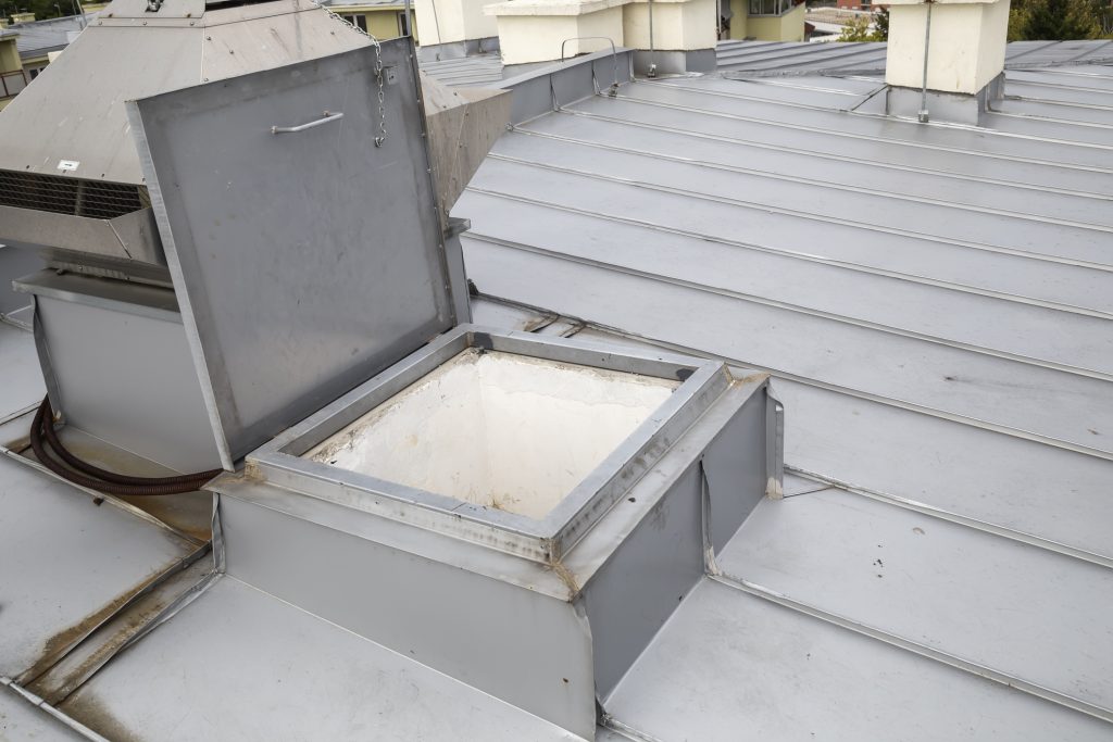 Metal roof access hatch, roof exit. Made with shallow depth of field.